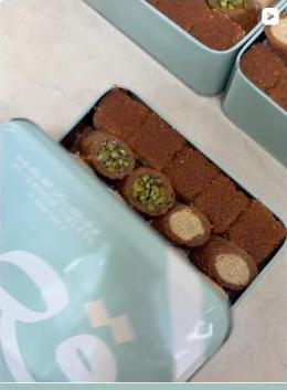 Fresh baklava rolls packed in a tin