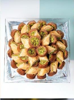 Fresh baklava with pistachio, arranged on a platter at Al Kassir Sweets